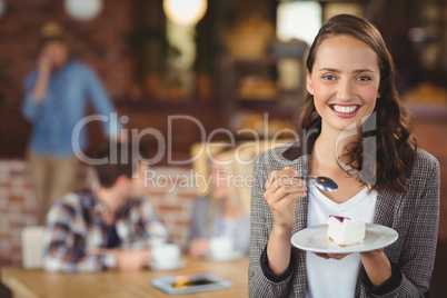 Smiling young woman holding cake