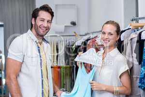 Smiling woman showing dress to boyfriend