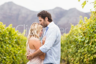 Young happy man kissing woman on the forehead