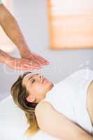 Close up view of pregnant woman getting reiki treatment