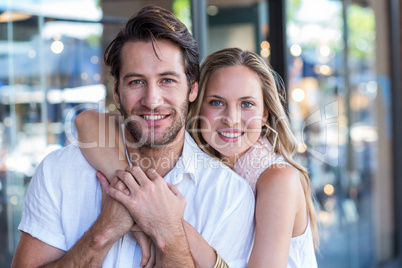 Smiling woman putting arm around her boyfriend