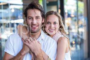 Smiling woman putting arm around her boyfriend