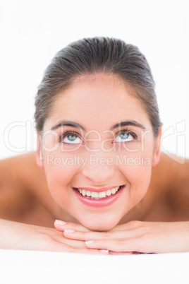 A portrait smiling pretty brunette on massage table