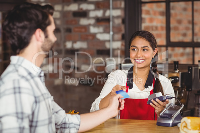 Customer handing a credit card to the waitress