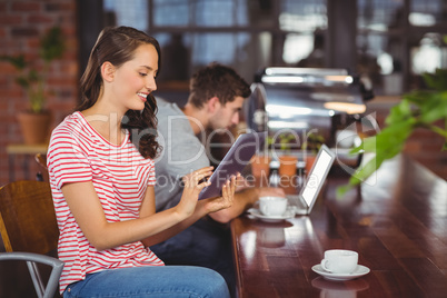 Smiling young woman using tablet computer