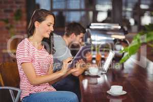 Smiling young woman using tablet computer