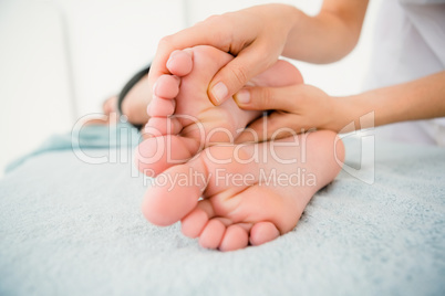 Close-up of a woman receiving foot massage