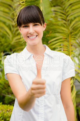 Pretty woman gesturing thumbs up before spa day