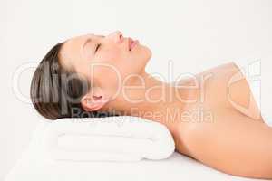 Woman lying on massage table at spa