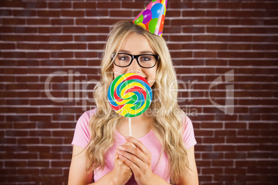 A beautiful hipster holding a giant lollipop