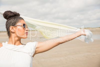 Stylish woman holding her scarf