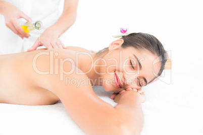 Beautiful brunette enjoying an oil massage
