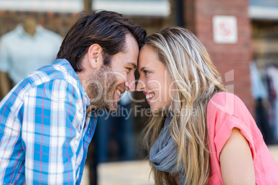 Cute couple sitting at a cafe head to head