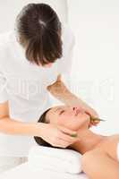Attractive young woman receiving aloe vera massage