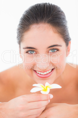 A portrait smiling pretty brunette on massage table