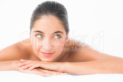 Beautiful brunette enjoying a salt scrub treatment