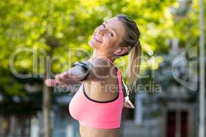 A beautiful athlete stretching her arms