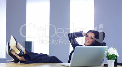 Businesswoman relaxing at her desk