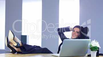 Businesswoman relaxing at her desk