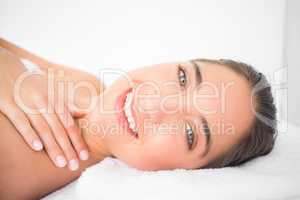 Beautiful young woman on massage table at spa center