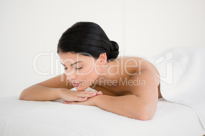 Pretty brunette enjoying a massage at camera