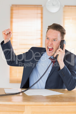 Furious businessman outraged on the phone
