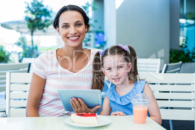 Mother and daughter using tablet computer together