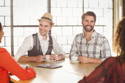 Laughing friends having coffee together