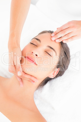 Attractive woman receiving head massage at spa center