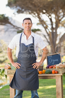 Smiling farmer standing with hands on hips