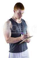 Fit personal trainer writing on clipboard