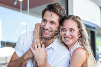 Smiling woman putting arm around her boyfriend