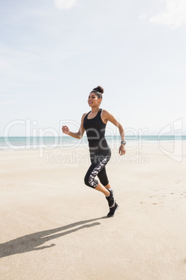 Fit woman jogging on the sand