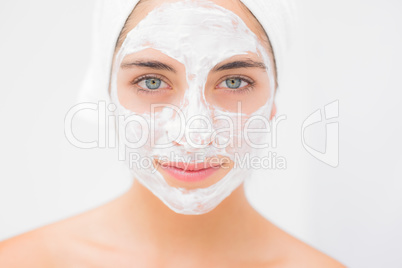 Attractive woman having white cream on her face