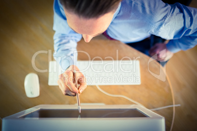 Businessman pointing to screen with pen