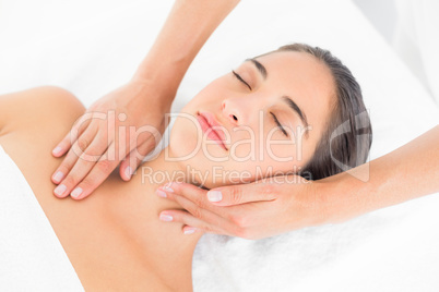 Attractive woman receiving head massage at spa center