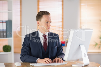 Focused businessman working at his desk Focused businessman working at his desk