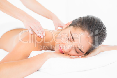 Attractive woman receiving back massage at spa center