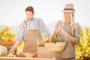 Blonde customer holding a vegetables basket