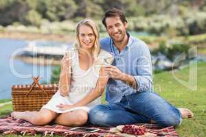 Couple on date toasting with glass of white wine