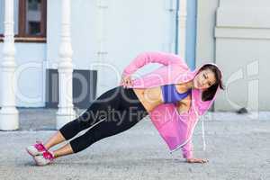 Athletic woman exercising side plank
