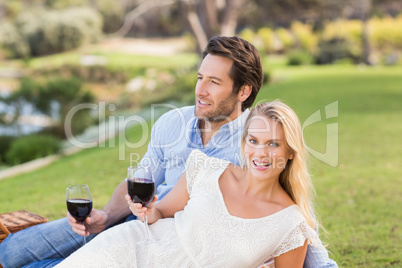 Cute couple on date holding red wine glasses
