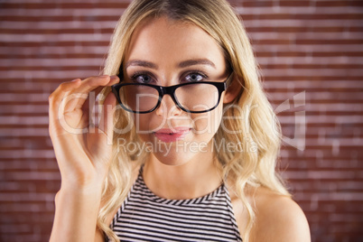 Gorgeous blonde hipster posing with glasses