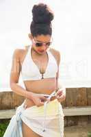 Pretty woman in bikini measuring her waist