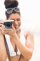 Pretty hipster in bikini taking picture