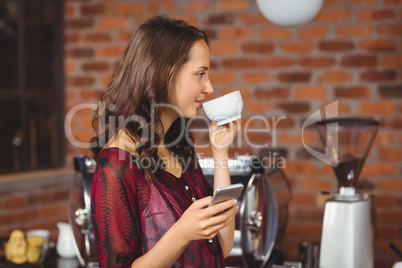 A pretty woman drinking a coffee