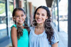 Portrait of a mother and her daughter smiling