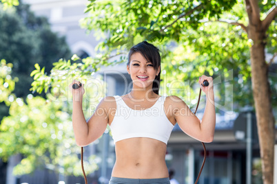 Portrait of smiling athletic woman skipping