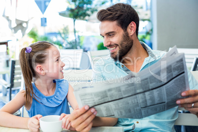 Happy father and his daughter having breakfast together