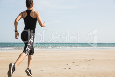 Fit woman jogging on the sand